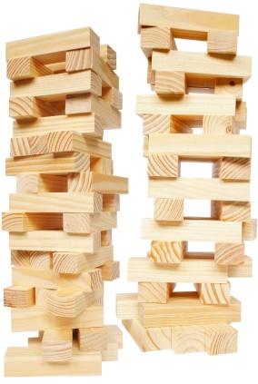 two Jenga towers on the brink of collapse
