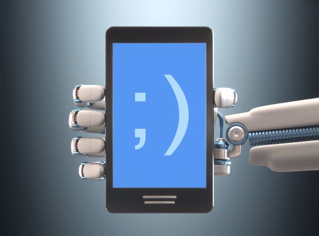 A robot hand holding a smartphone showing a smiley: copyright www.istockphoto.com 50529790