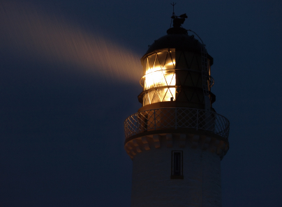A lighthouse light at night