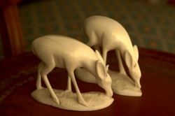 two ivory-coloured deer figurines