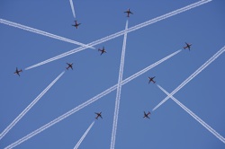 The trails of many planes cross in the sky