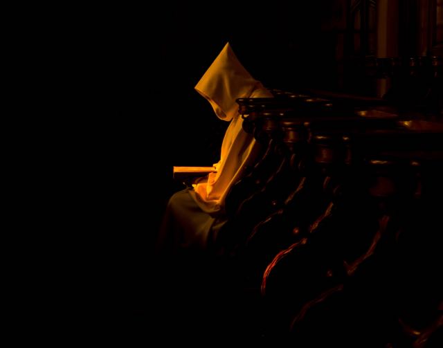 A monk praying in the dark : copyright www.istockphoto.com 74238125