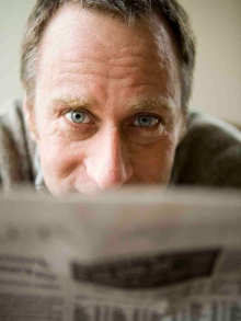 A man looking over a newspaper
