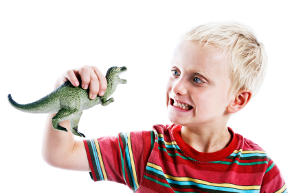 A small boy with a toy dinosaur