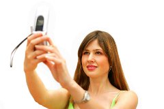 A woman using a mobile to photograph herself